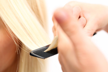 Image showing Hairdressing Hairdresser combing woman