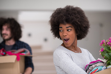 Image showing multiethnic couple moving into a new home