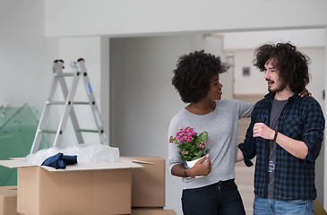 Image showing multiethnic couple moving into a new home