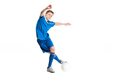 Image showing Young boy with soccer ball doing flying kick