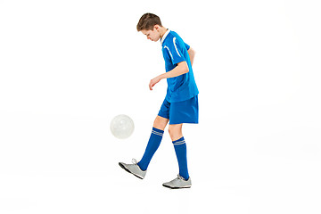 Image showing Young boy with soccer ball doing flying kick