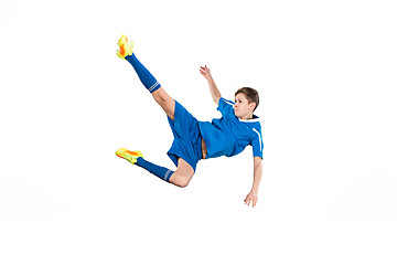 Image showing Young boy with soccer ball doing flying kick