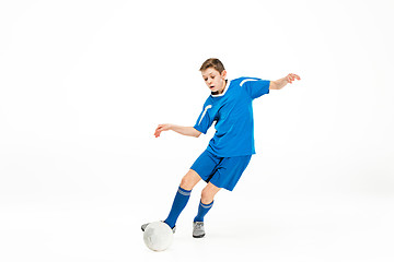 Image showing Young boy with soccer ball doing flying kick