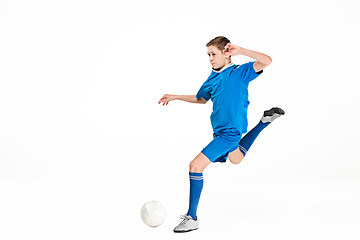 Image showing Young boy with soccer ball doing flying kick