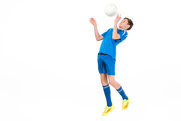 Image showing Young boy with soccer ball doing flying kick