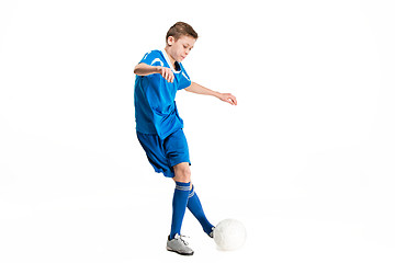 Image showing Young boy with soccer ball doing flying kick