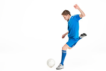 Image showing Young boy with soccer ball doing flying kick