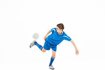 Image showing Young boy with soccer ball doing flying kick