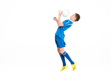 Image showing Young boy with soccer ball doing flying kick