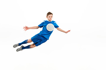 Image showing Young boy with soccer ball doing flying kick