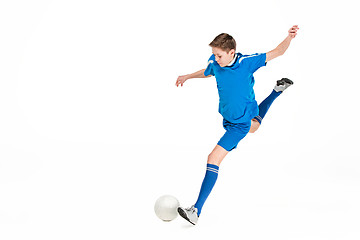 Image showing Young boy with soccer ball doing flying kick