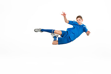 Image showing Young boy with soccer ball doing flying kick