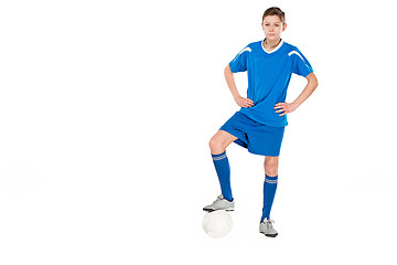 Image showing Young boy with soccer ball doing flying kick