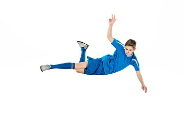 Image showing Young boy with soccer ball doing flying kick