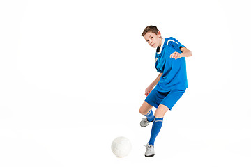 Image showing Young boy with soccer ball doing flying kick