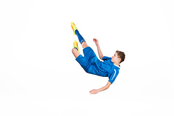 Image showing Young boy with soccer ball doing flying kick