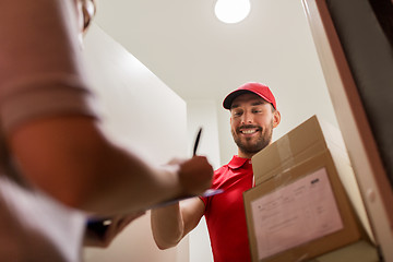 Image showing deliveryman and customer with parcel boxes at home