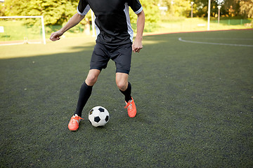 Image showing soccer player playing with ball on football field