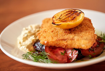 Image showing close up of fish salad with roasted lemon on plate