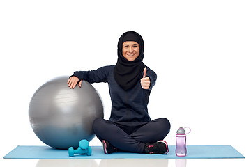 Image showing muslim woman in hijab with fitness ball and bottle