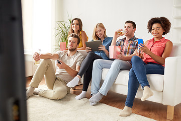 Image showing friends with gadgets and beer watching tv at home