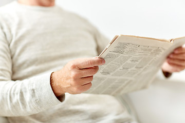 Image showing close up of senior man reading newspaper