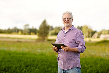 Image showing senior man with tablet pc computer at county