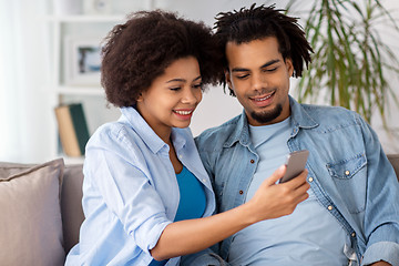 Image showing happy couple with smartphones at home