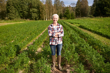 Image showing happy senior woman at farm