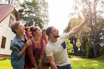 Image showing friends taking selfie at party in summer garden