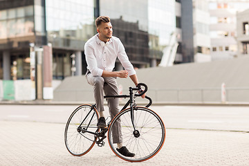 Image showing man with bicycle and headphones on city street