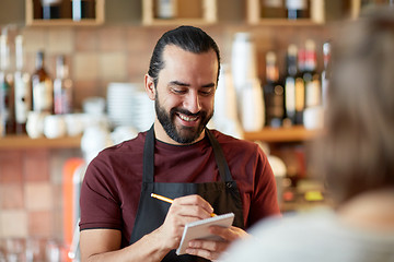 Image showing man or waiter serving customer at bar
