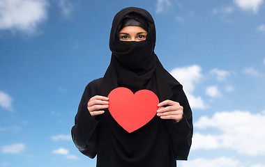 Image showing muslim woman in hijab holding red heart