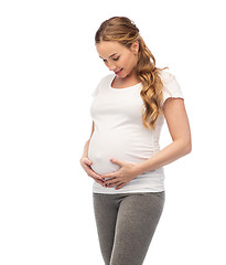 Image showing happy pregnant woman touching her big belly