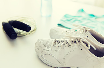 Image showing close up of sportswear, skipping rope and bottle