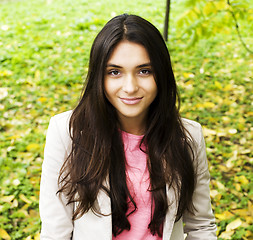 Image showing Young cute smiling real stylish dressed woman in green palm park smiling, resting, enjoing, lifestyle outside concept