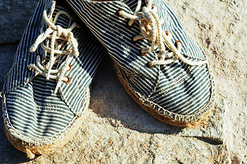 Image showing picture of vintage old shabby sneakers at seacost, real forgotte