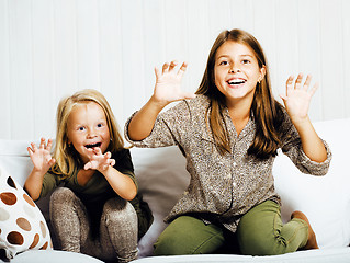 Image showing two cute sisters at home playing