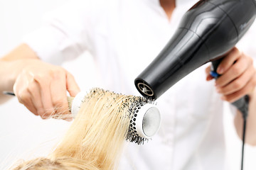 Image showing Combing the hair drying brush