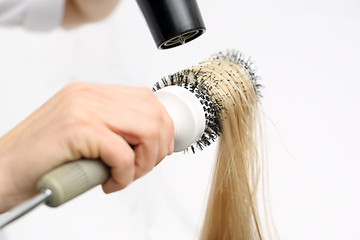 Image showing Combing the hair drying brush