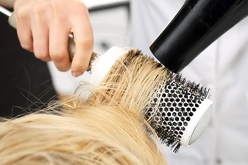 Image showing Drying hair on a round brush