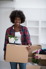 Image showing Black girl moving in the new apartment