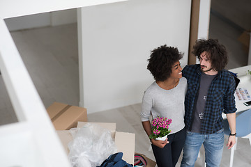 Image showing multiethnic couple moving into a new home