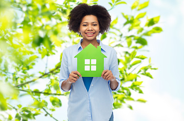 Image showing happy african american woman with green house icon