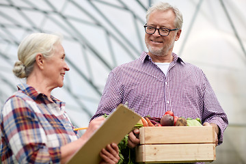 Image showing senior couple with box of vegetables on farm