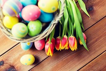 Image showing close up of easter eggs in basket and flowers