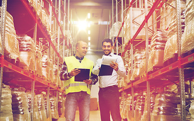 Image showing worker and businessmen with clipboard at warehouse