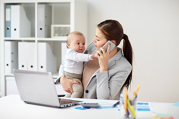 Image showing businesswoman with baby and smartphone at office