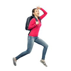 Image showing happy woman or student with backpack jumping