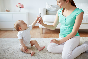 Image showing happy mother and baby playing at home